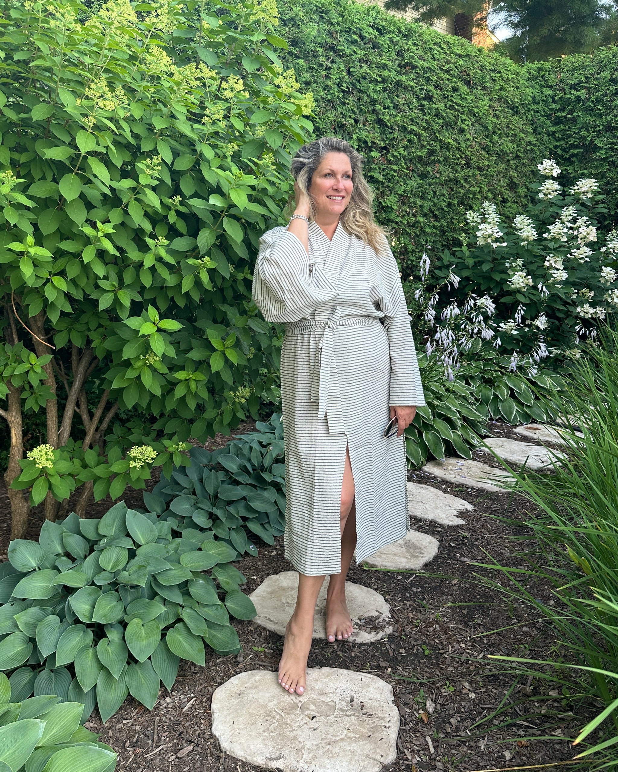 A woman in a light Emma kimono in a garden