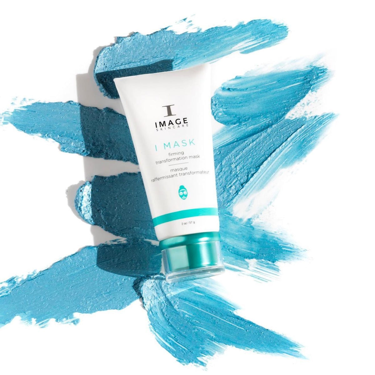 White Image Skincare I MASK firming transformation mask tube with a teal cap on swatches of blue mask