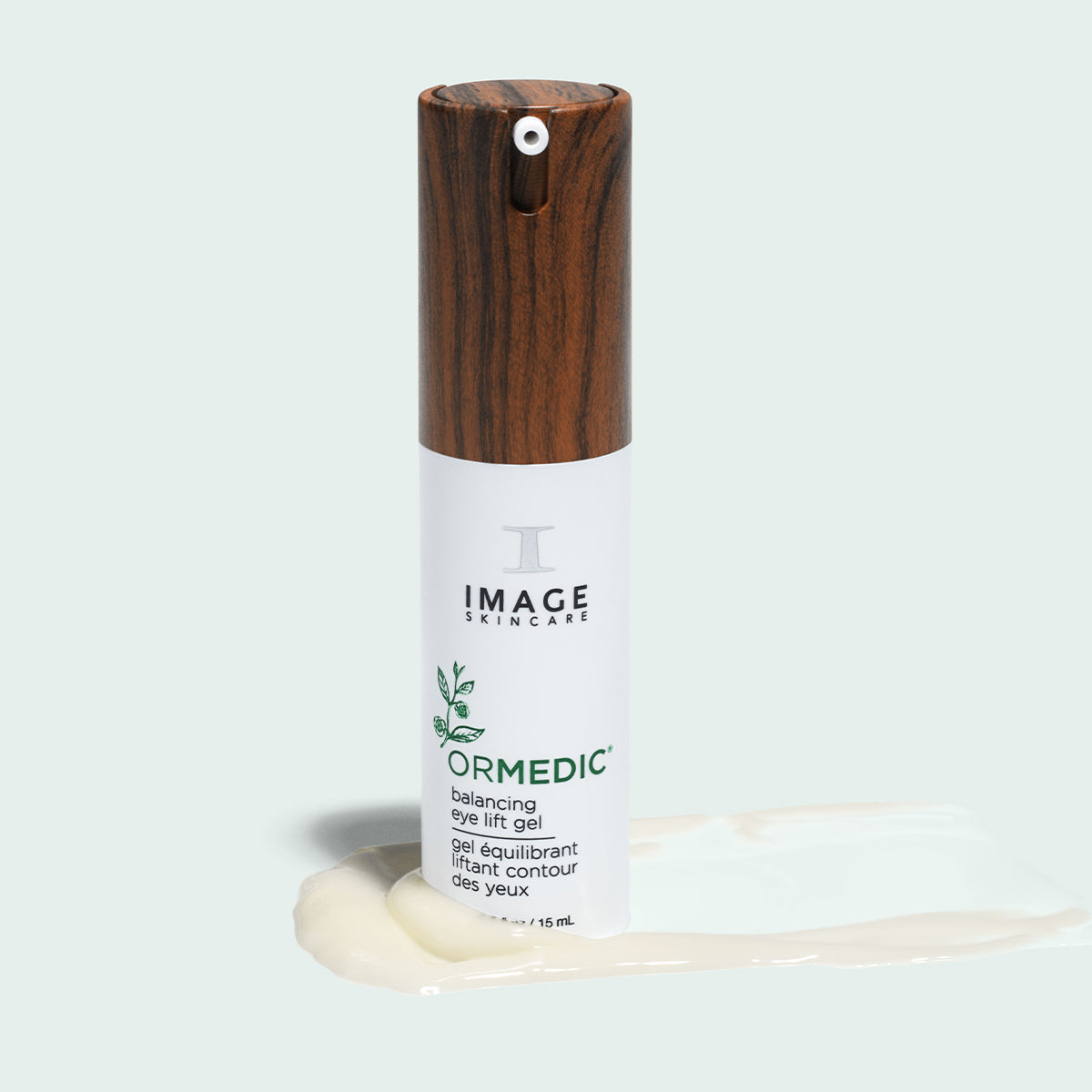 Image Skincare ORMEDIC balancing eye lift gel bottle standing on a swatch of creamy gel, pale background