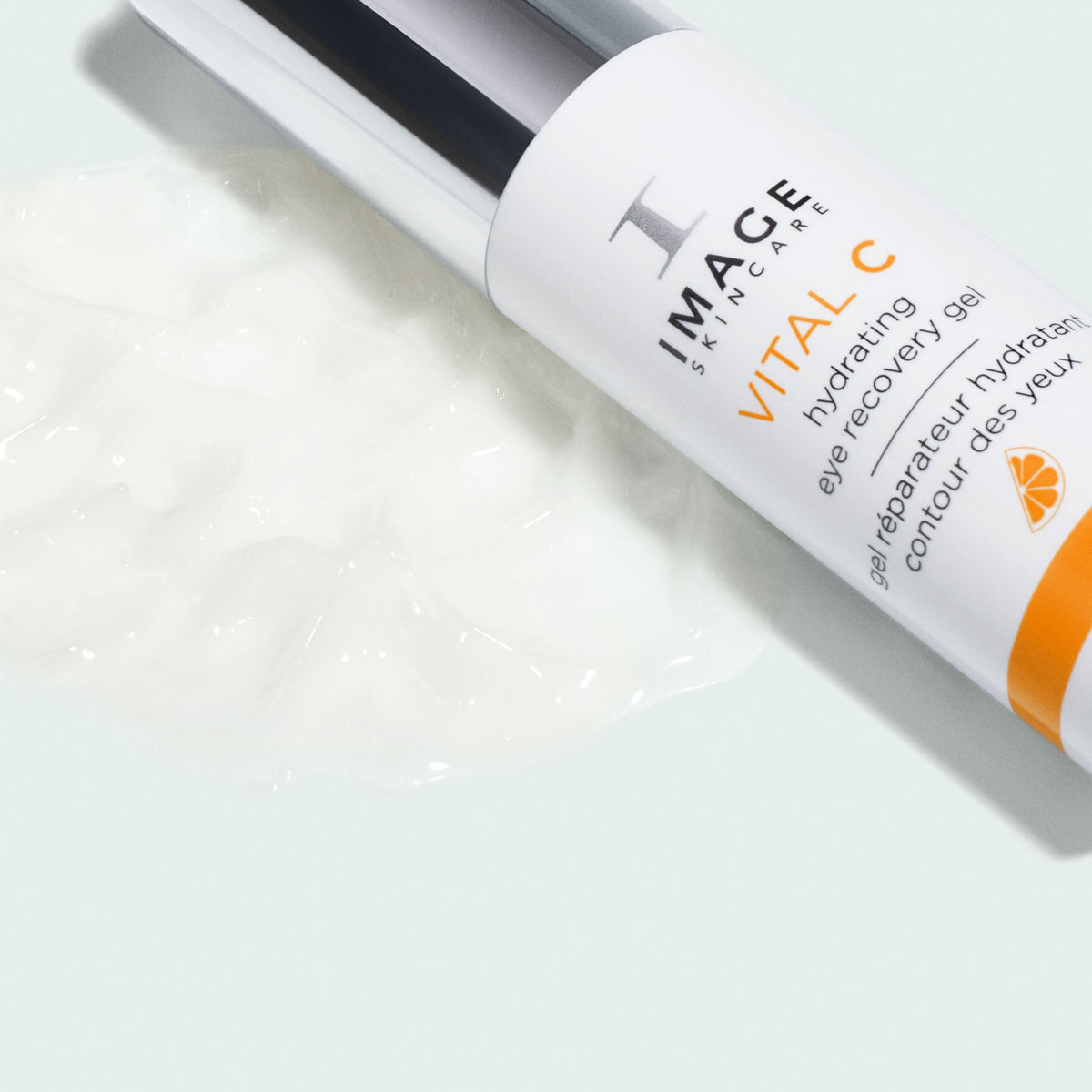 Image Skincare VITAL C hydrating eye recovery gel bottle lying beside a swatch of white gel