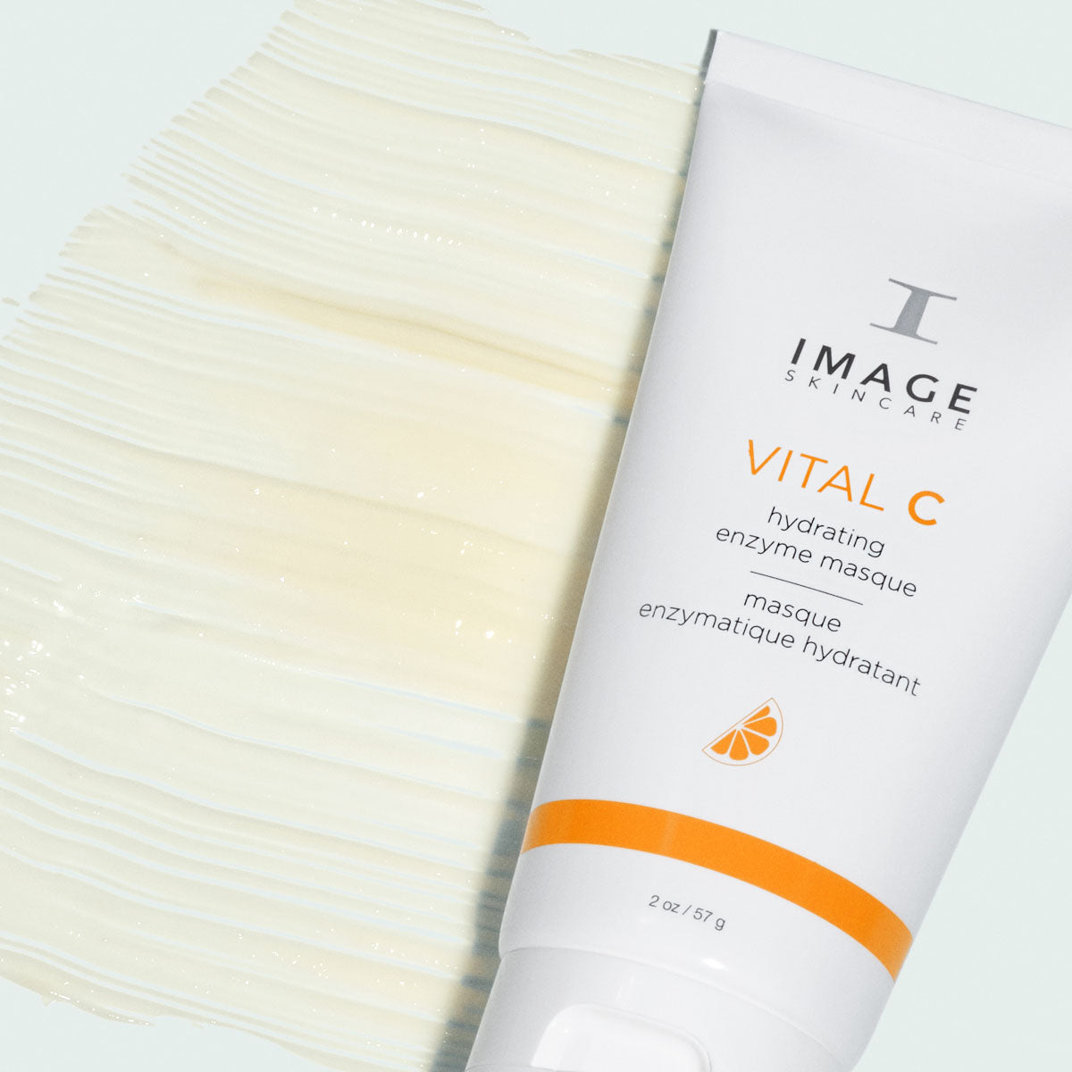 White and orange tube, Image Skincare VITAL C hydrating enzyme masque, beside a wide swatch of creamy texture