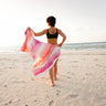 Woman walking at the beach showing her Balmy Sundae towel